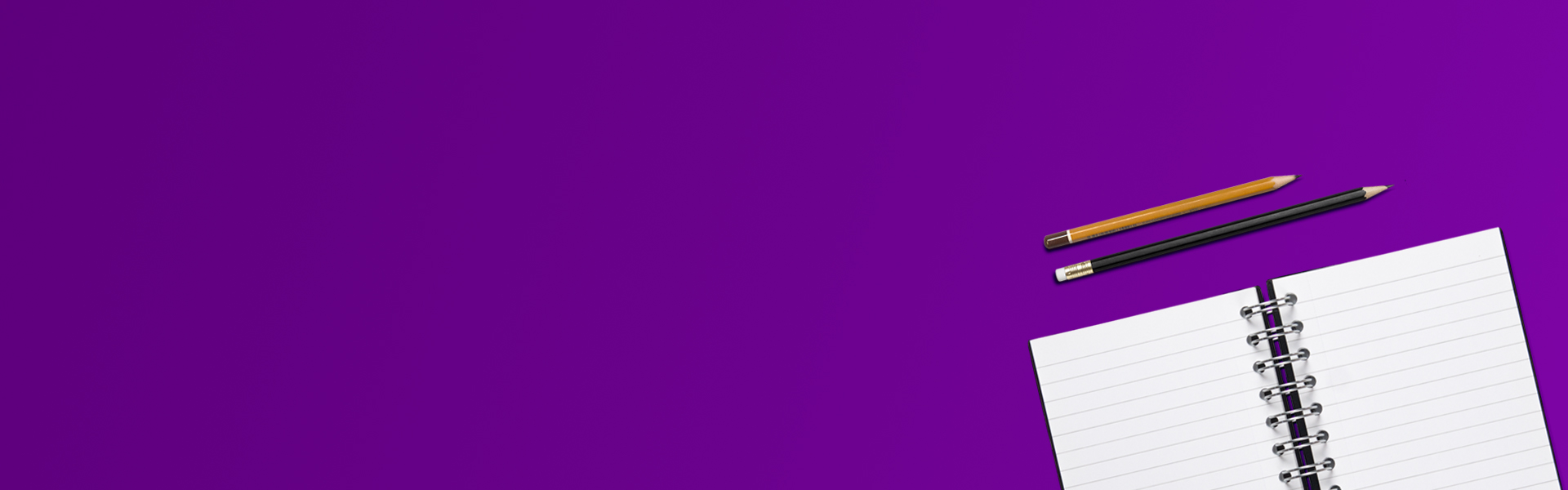 Image of an open notebook with a black and orange pen rest above on a solid purple background