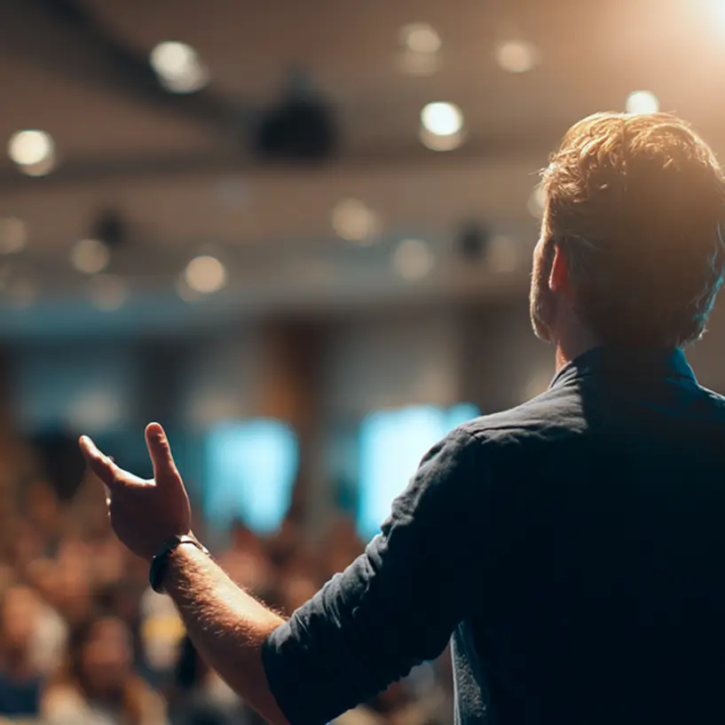 Cropped image of a keynote speaker on stage addressing a large audience at Node Talks 2026