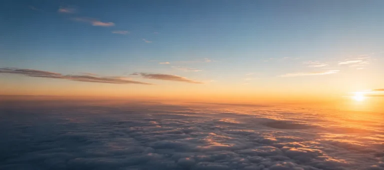 Image of a clear sky above the clouds at sunset.