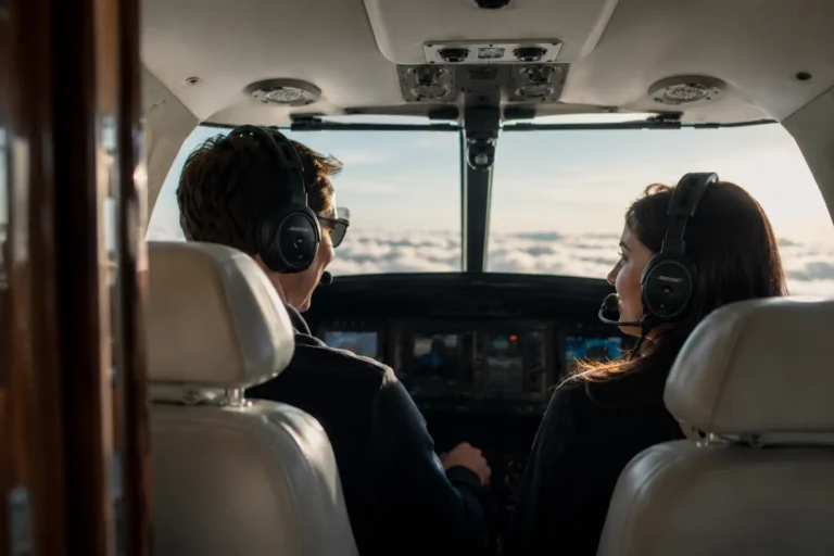 A man and a woman in the cockpit of a plane.